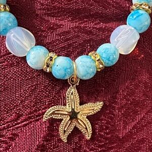 Gold-Tone Starfish Pendant Charm Bracelet with Sky Blue/Clear Glass Beads